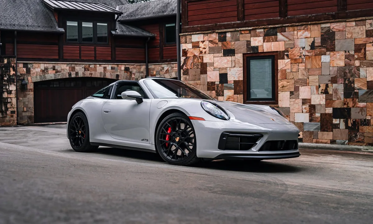 Silver Porsche 911 Cabriolet outside a stone-fronted building