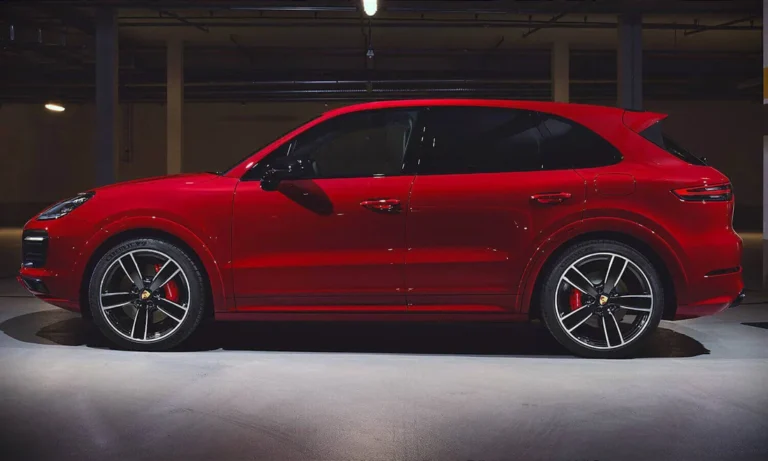 Red Porsche Cayenne in side profile