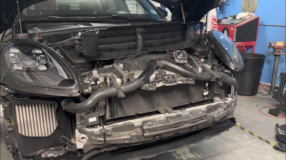 Front cooling components exposed during a Porsche workshop repair