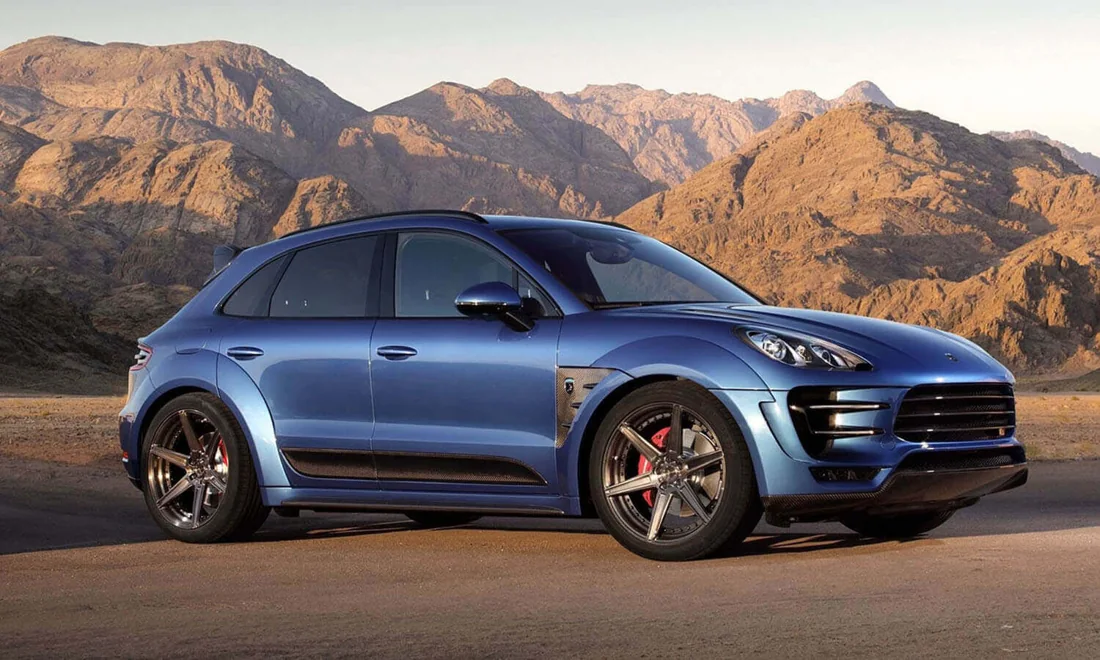 Blue Porsche Macan in a mountain setting
